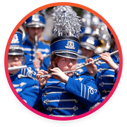 Marching band member playing instrument in performance 