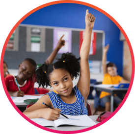 Young girl raising her hand in a public school classroom