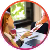 Person giving gift to a recipient