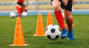 Youth soccer player practicing a drill