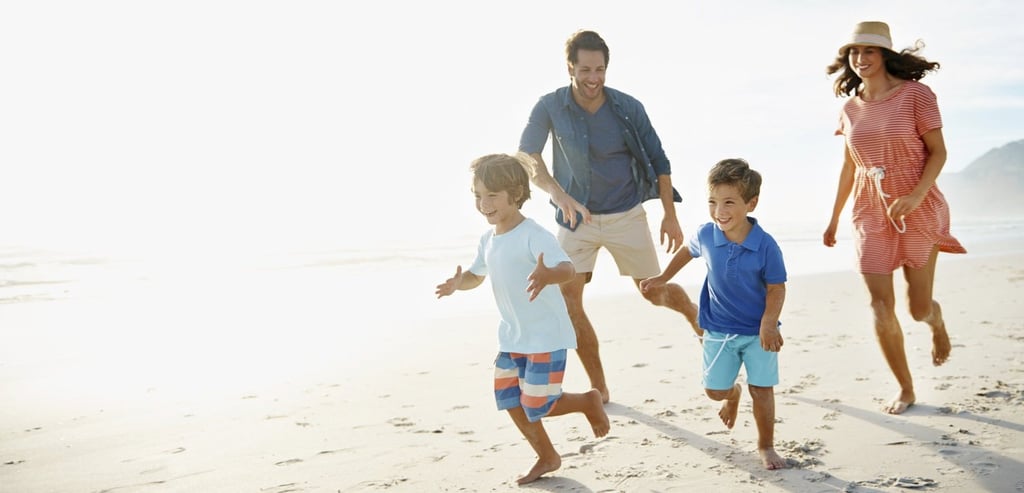 Family-running-on-beach