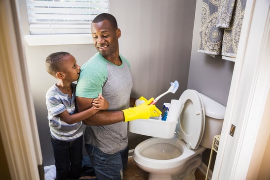 Father and son cleaning the bathroom