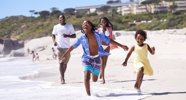 family_running_on_beach