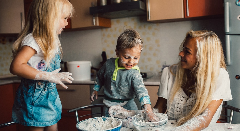 Kids in the kitchen baking cookies with their mom
