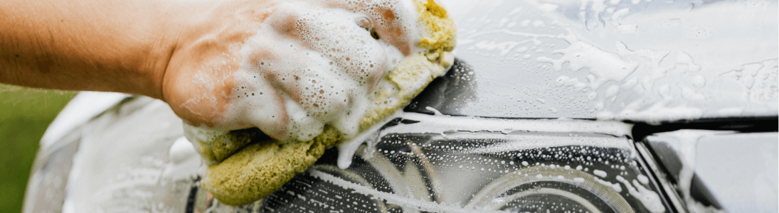 using a sponge to clean a car at a car wash fundraiser