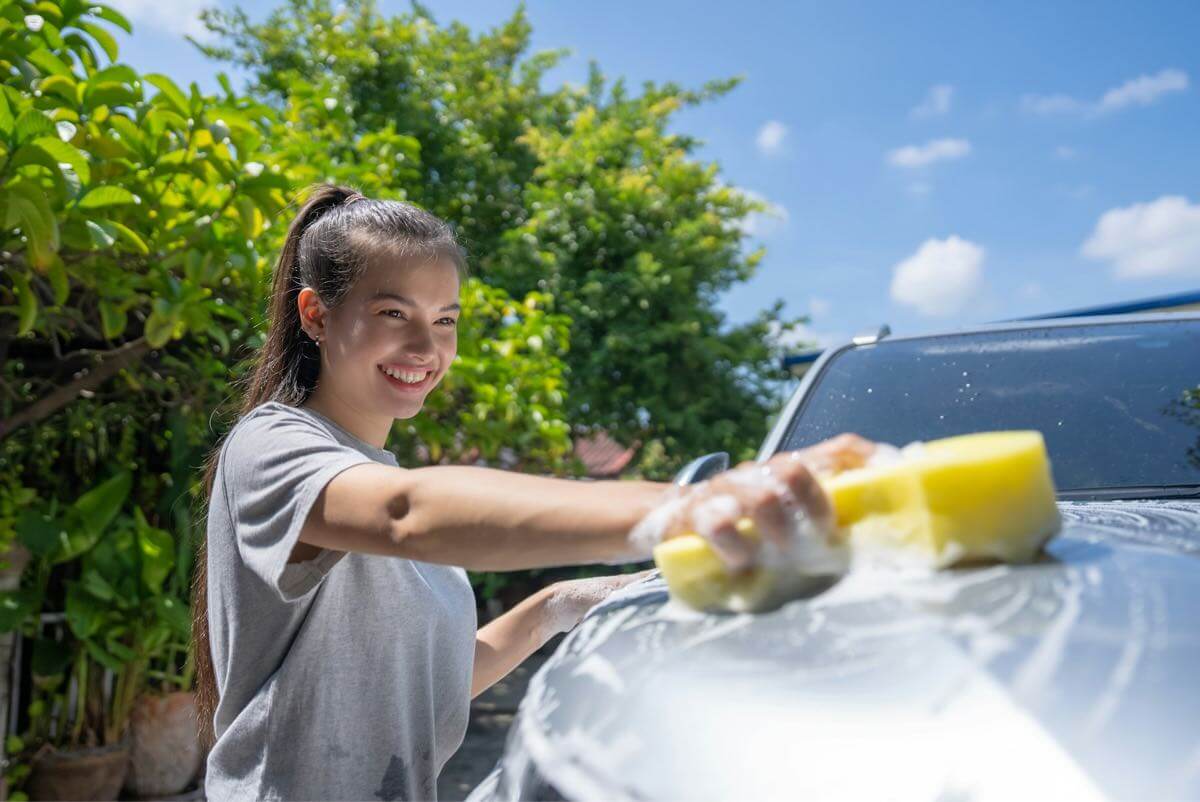 girl washing at a car at a car wash fundraiser