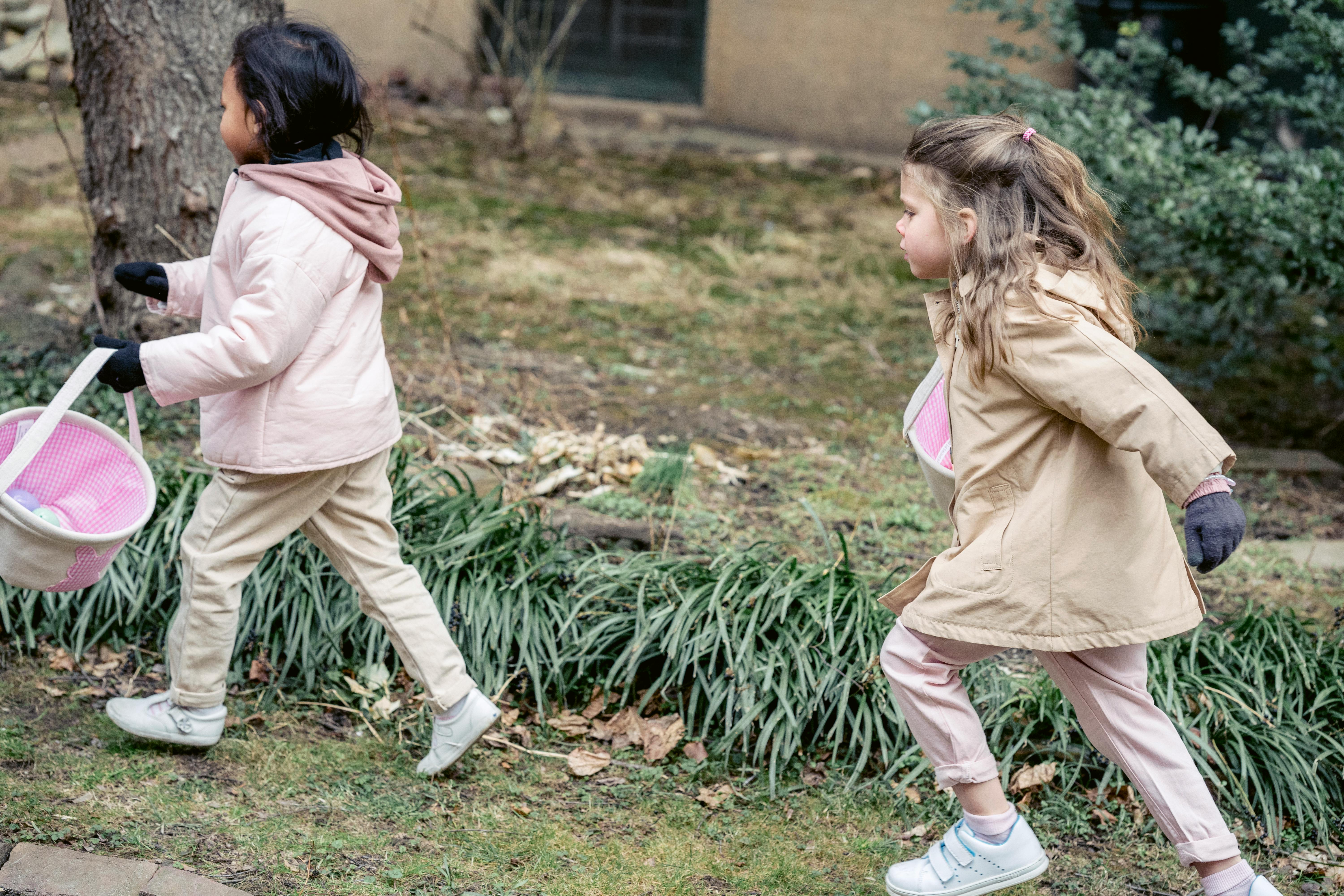 two girls going on an easter egg hunt