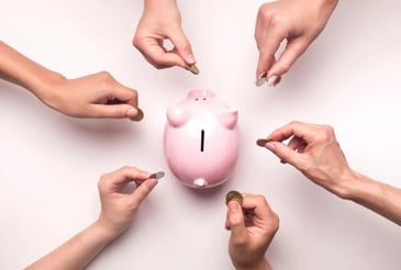 crowdfunding depiction with hands putting coins into a piggy bank