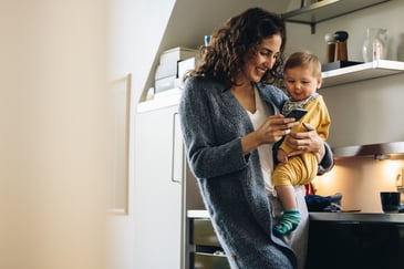 busy mom using her phone to fundraise on the go