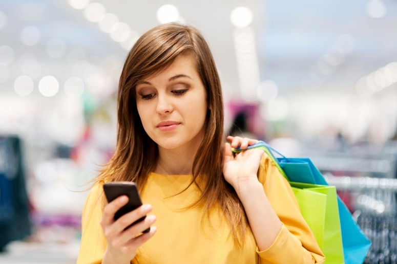 Woman on mobile device while shopping