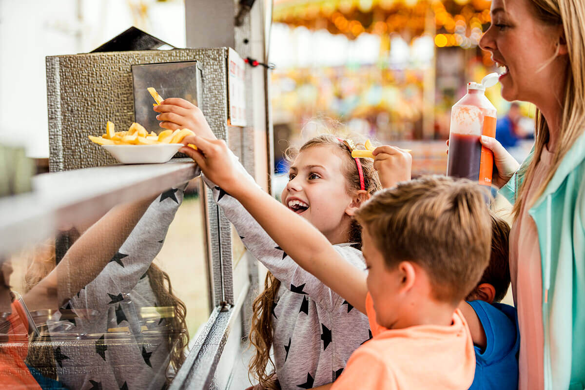 kids and mom at a concession stand fundraiser