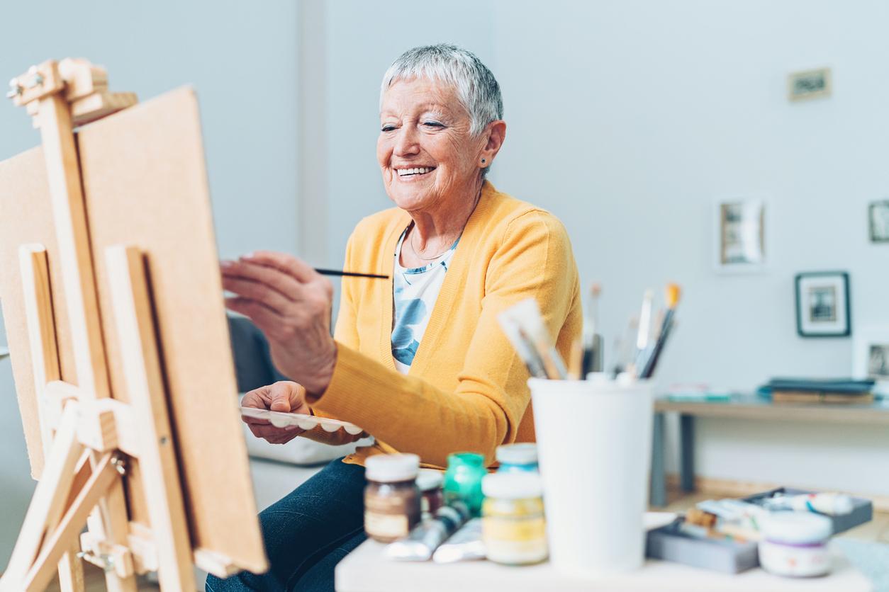 older woman mom painting in craft room