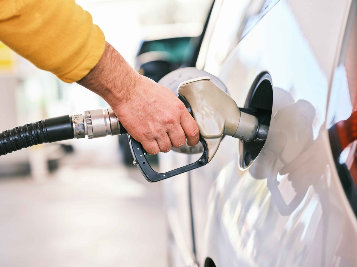 person pumping gas at the gas station