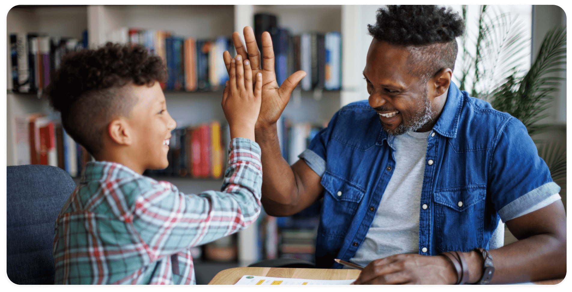 father and son giving each other a high five