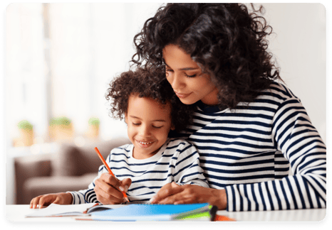Mother helping young child with homework