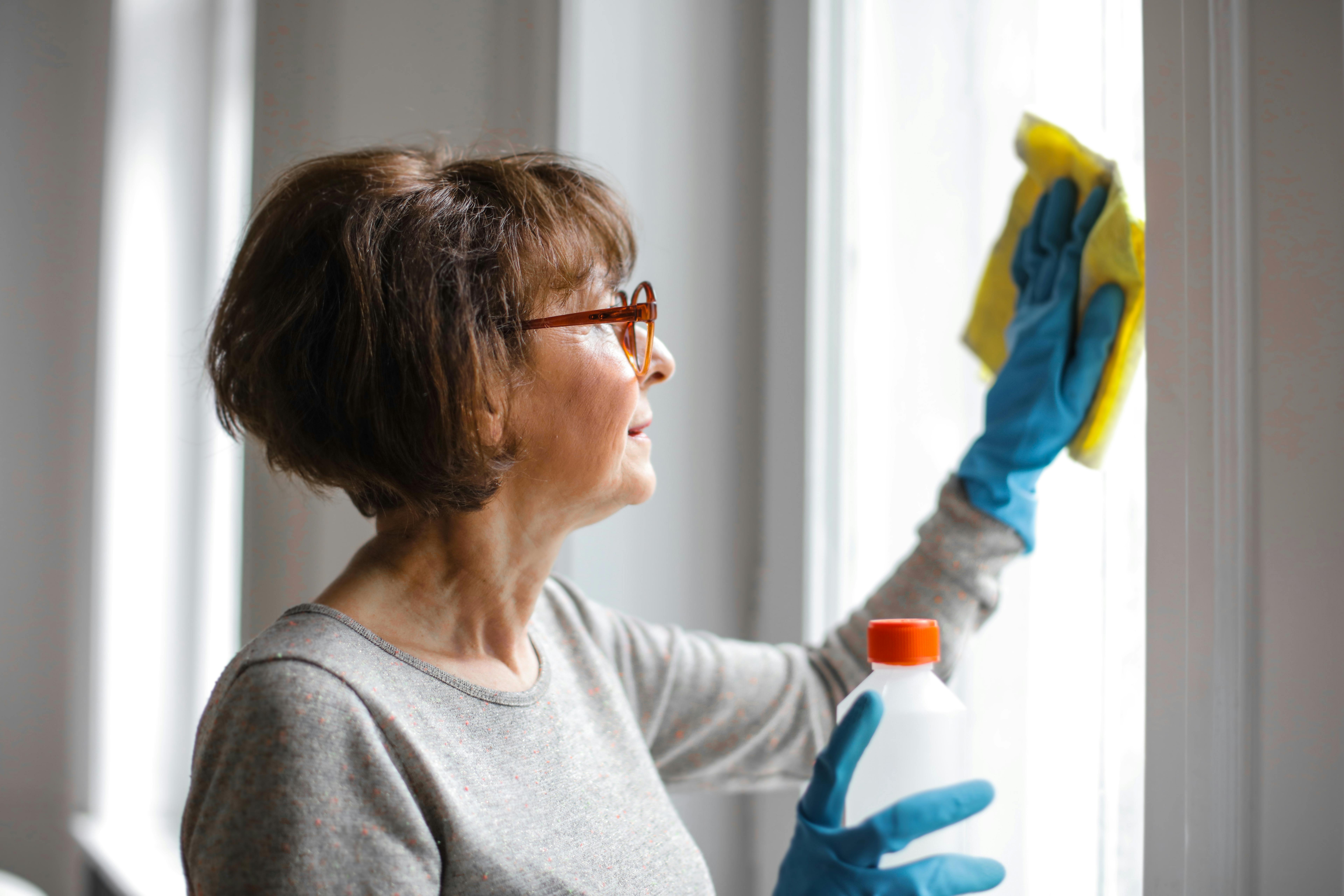 woman cleaning windows at home