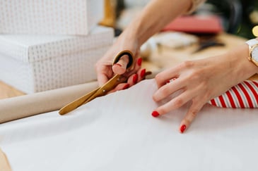 person cutting wrapping paper for their fundraiser