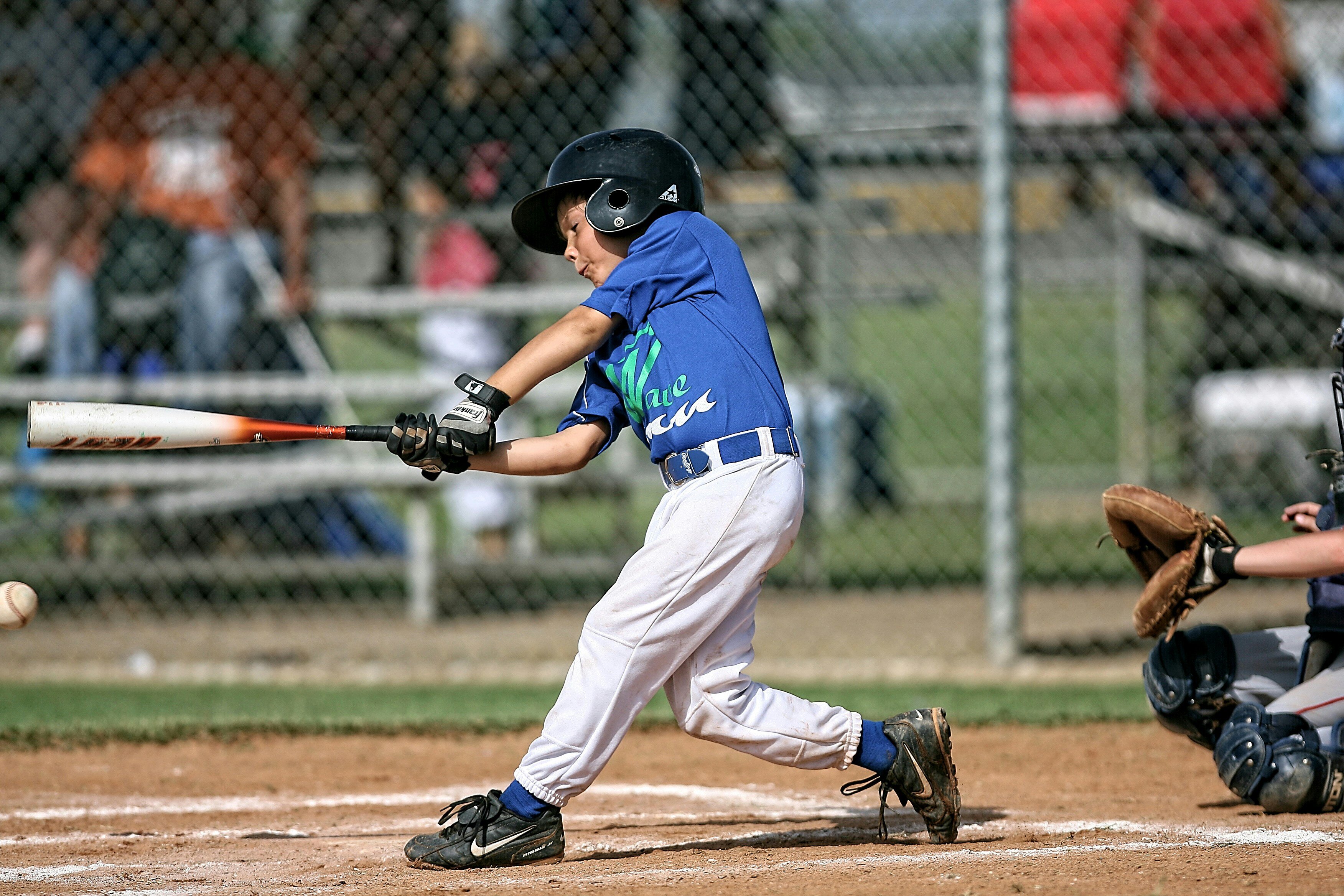 youth baseball player swinging a baseball bat