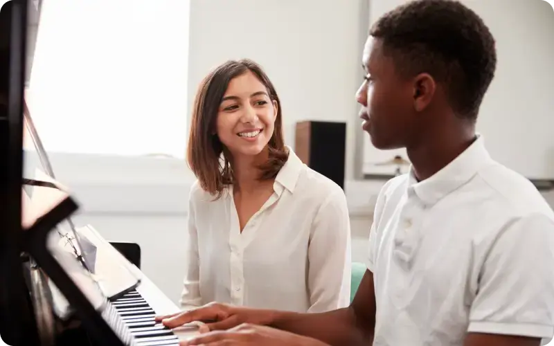 piano teacher and student rehearsing