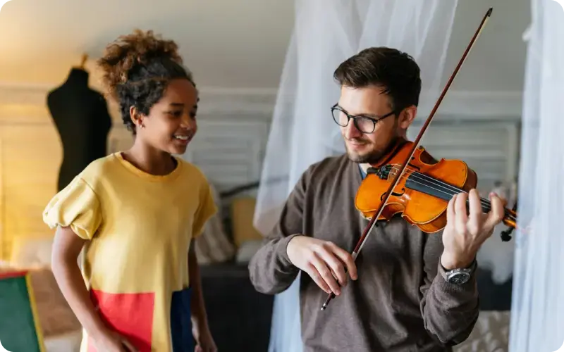 violin instructor and student practicing