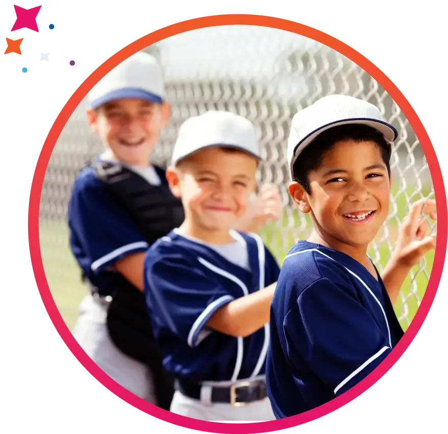 Boys youth baseball team members standing by a fence-1 (1)