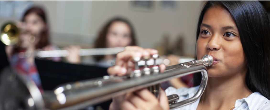 Girl playing instrument in band practice