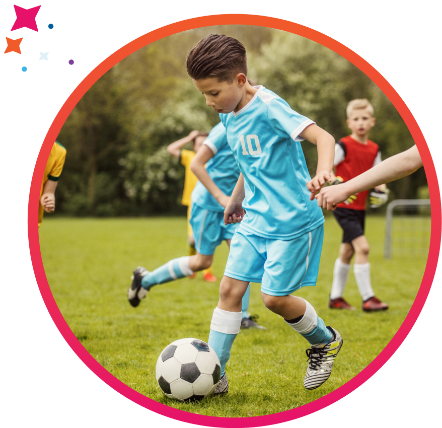 Youth soccer player running with the ball