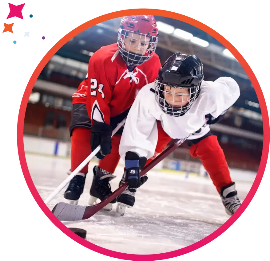 Youth hockey players reaching for the puck in a match